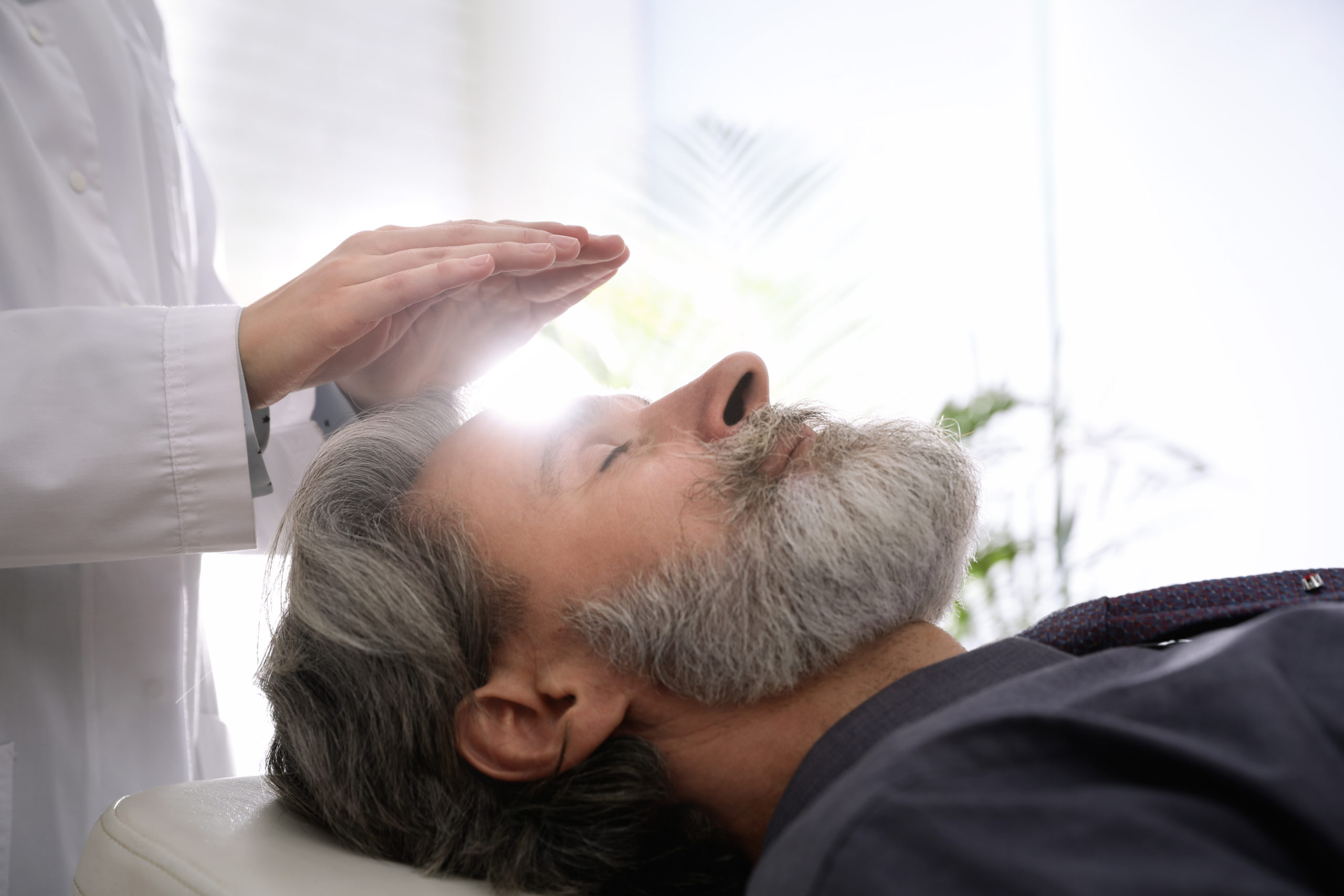 A bearded man lying down, perhaps relaxing or taking a break, enjoying a moment of rest